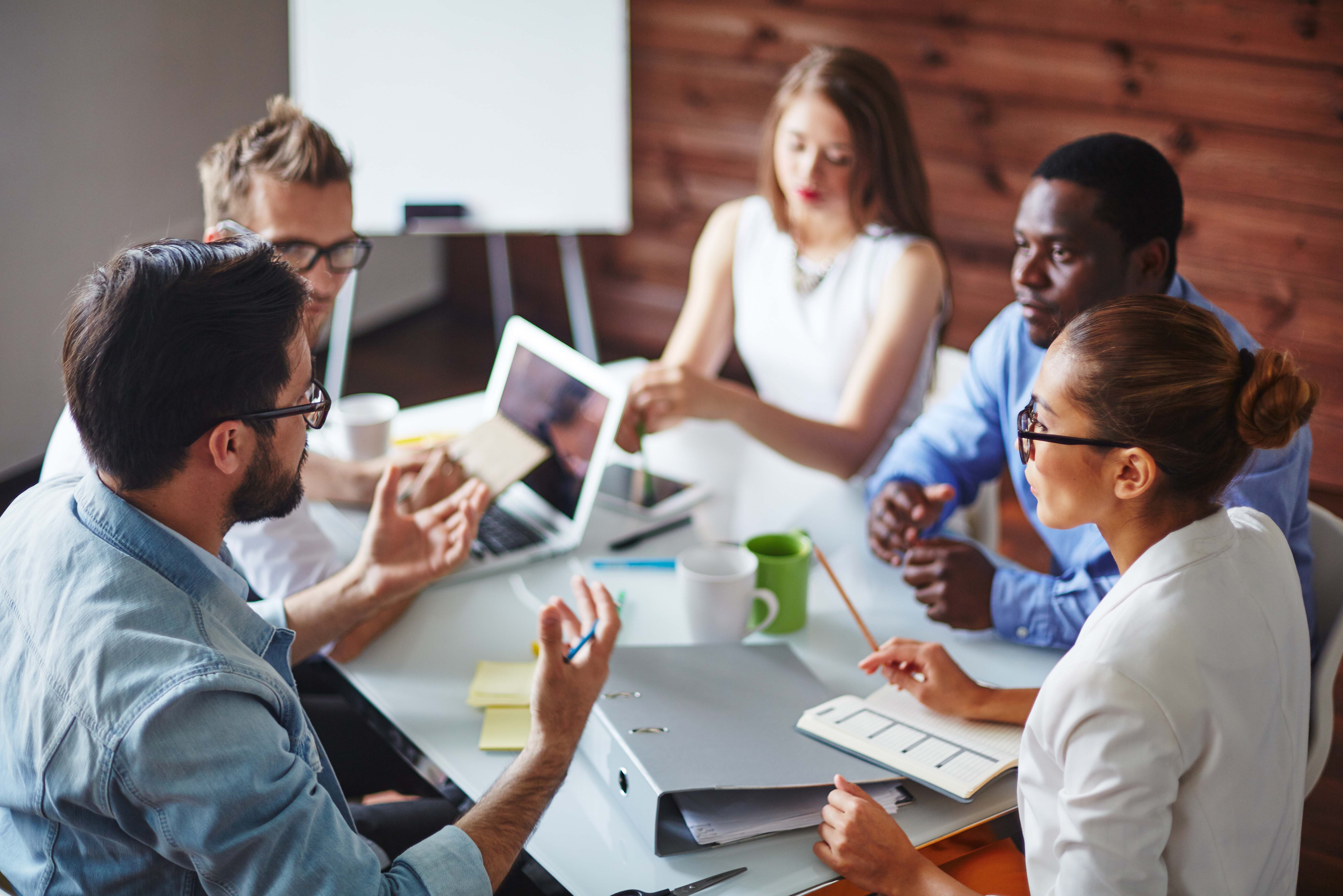 Business professionals meeting at a table to discuss process development