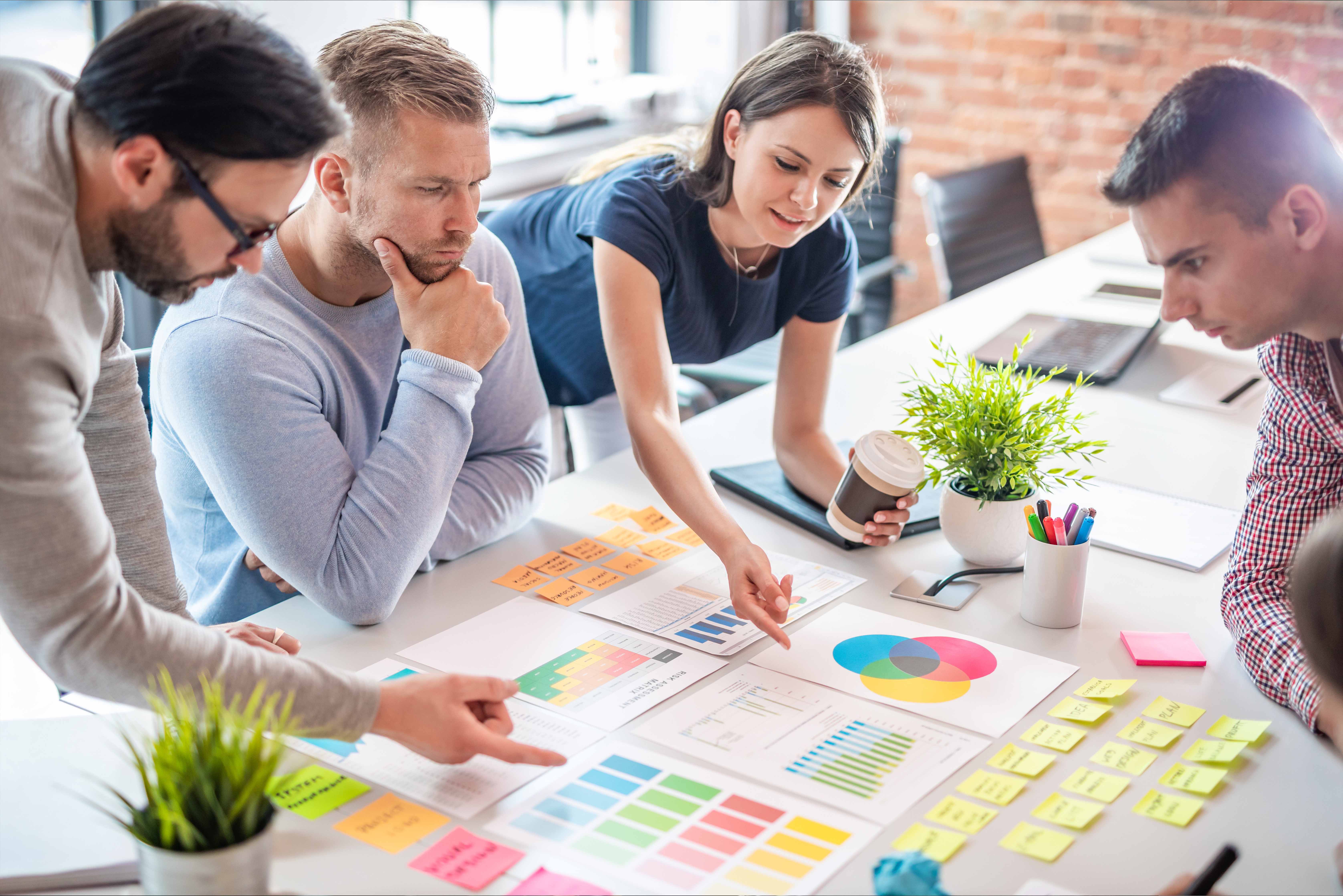 Business team meeting to go over documents laid out on the table